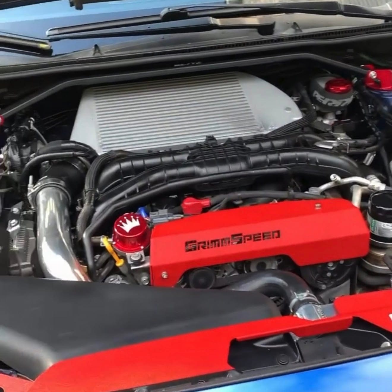 A cleaned and dressed engine bay with a red intercooler cover