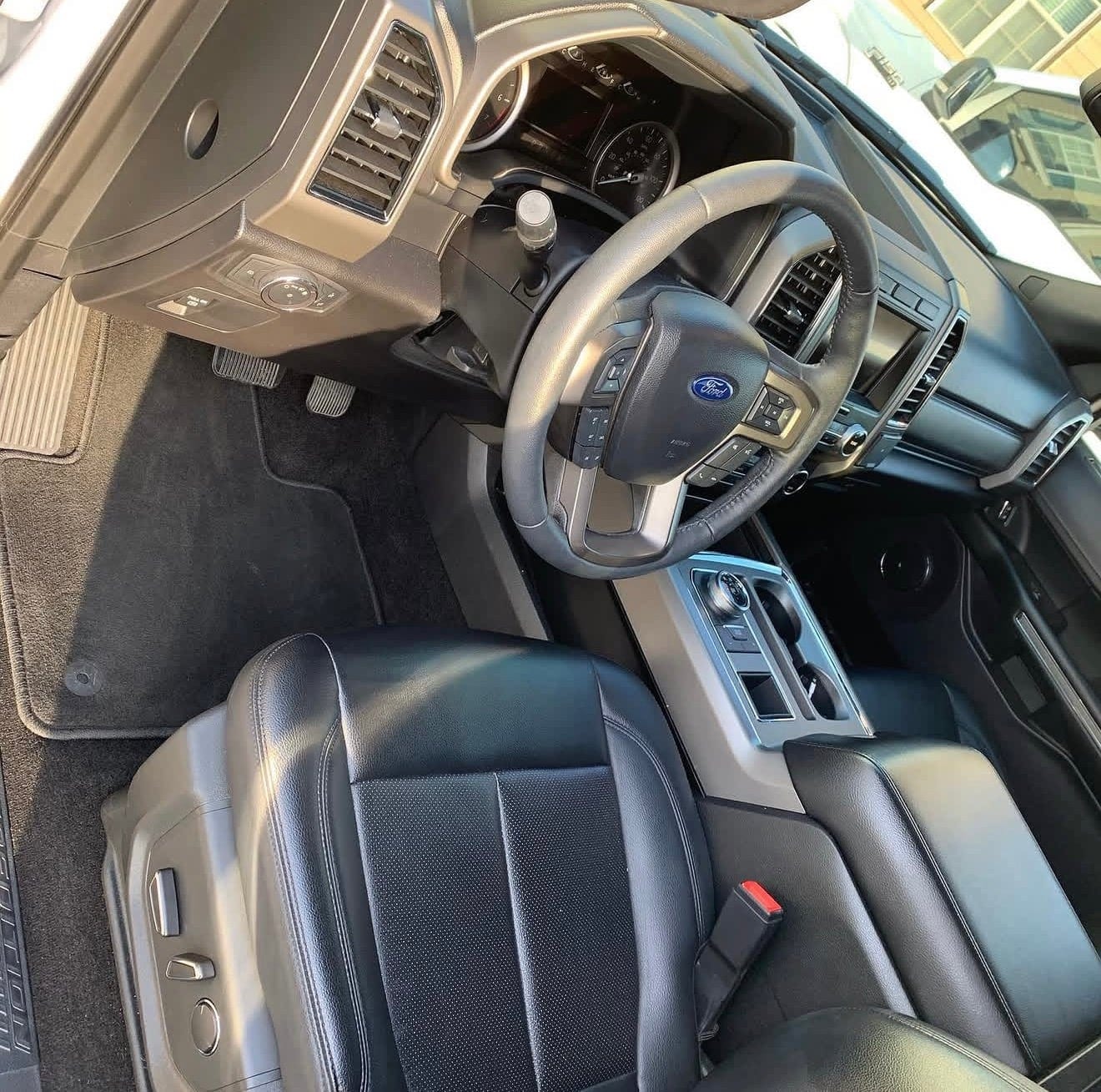 The cleaned leather interior of a Ford pickup, driver's side